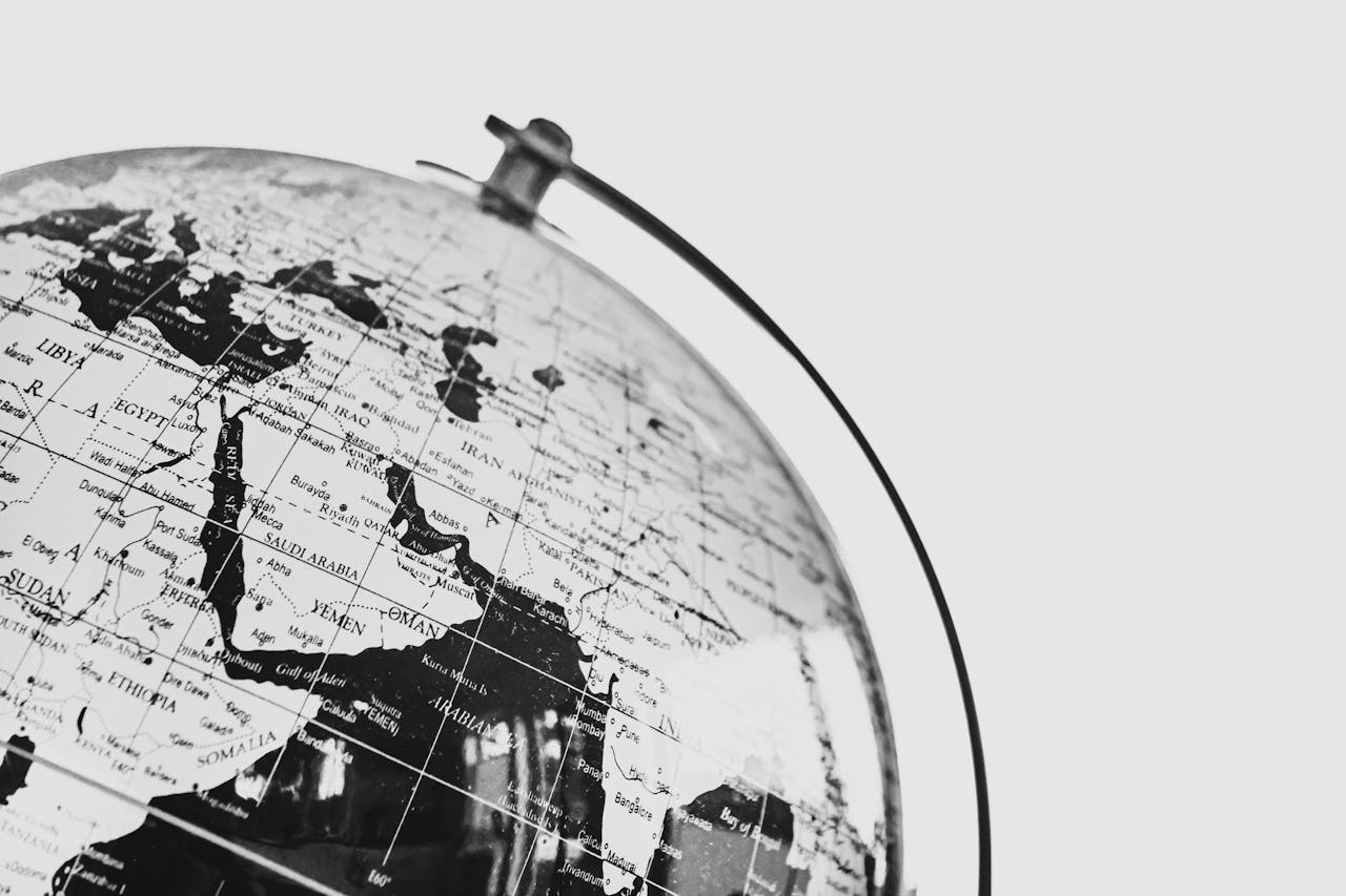 Monochrome photo of a globe focusing on the Middle East region, depicting political boundaries.